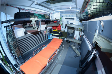 Interior of a military emergency vehicle: stretcher, bags, medical equipment