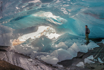 beautiful blue ice glacier cave grotto inside the mountain glacier Alibek, Dombay