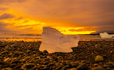 Ice chunk on the famous Diamond beach in Iceland during sunset