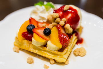 Waffle and fruit with honey and icecream