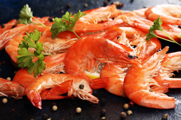 Raw fresh Prawns Langostino Austral. shrimp seafood with lemon and spices on dark