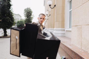 A stylish young man with bags after successful shopping on Black Friday