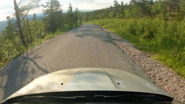 Windshield view of car driving on mountain road in Finland