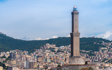 Fototapeta na wymiar GENOA - August 14 2019: The lighthouse of Genoa (La Laterna), with city in a background.