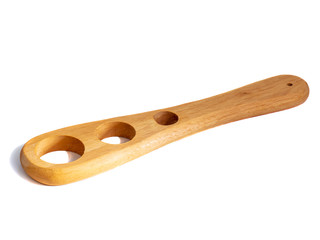 Wooden pasta measuring tool isolated on a white background.
