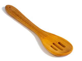 Wooden pasta slotted spoon isolated on a white background.