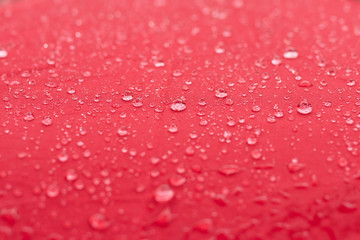 Raindrops on the surface of a red cloth