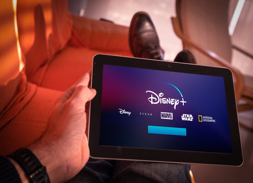 Barcelona, Spain. January 2019: Man holds a tablet with the new Disney plus on screen