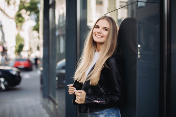 Young girl posing next to the shopping centre on Black Friday