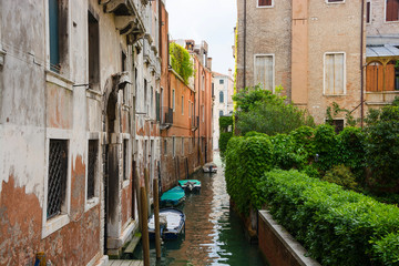 Fototapeta na wymiar View of the city narrow street and canal in Venice on a sunny day