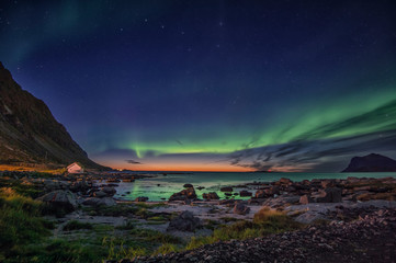 Aurora Borealis  hovering above an arctic sunset