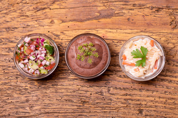 three mexican salsas on dark wood