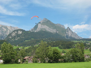 Gleitschirmflieger am Horizont mit Berg im Hintergrund - Wildhaus - Schweiz