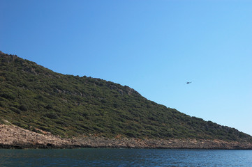 Fototapeta na wymiar A helicopter over an island near Kaş, Turkey