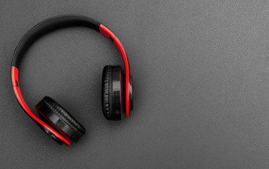Headphones on black background. Top view. Space for text.
