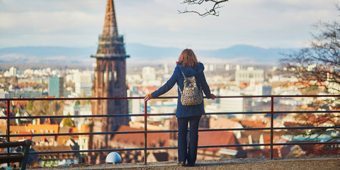 Girl enjoying panorama of Freiburg im Breisgau in Germany - obrazy, fototapety, plakaty