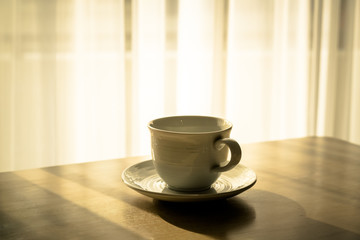 Hot coffee on table table near windows