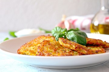 Fried potato pancakes on light background. Top view with copy space.