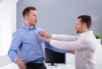 Businessman Fighting With His Colleague In Office