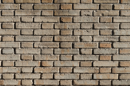Fondo con textura de muro de ladrillo caravista amarillo