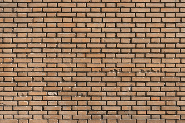 Fondo con textura de muro de ladrillo caravista naranja