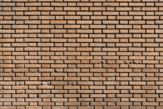 Fondo con textura de muro de ladrillo caravista naranja