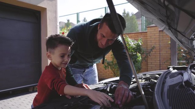 The father and son repair the car together