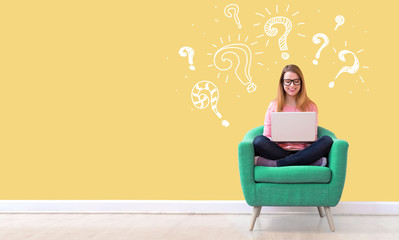 Question marks with young woman using her laptop in a chair