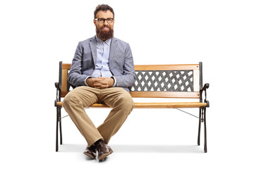 Bearded man sitting on a bench and smiling