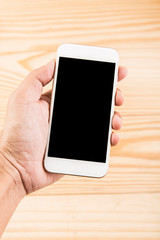 Blank smartphone on grunge wooden office table