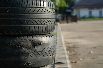 Old tires stacked, Close-up Broken tire damaged, A bunch of old tires from used cars. Environmental pollution. Dump tires