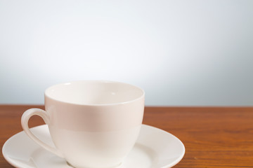 Fototapeta na wymiar Empty coffee mug on wooden table