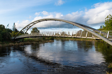 River Nith and Kirkpatrick Macmillan Pedestrian Bridge in Dumfries in Scotland. The River Nith is a river in south-west Scotland.