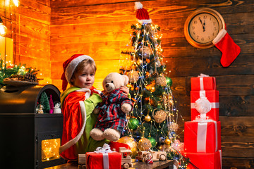 Cute little child boy play near christmas tree. Gifts and surprises. Merry christmas and happy new year. Kid enjoy winter holiday at home. Home filled with joy and love. Family day christmas
