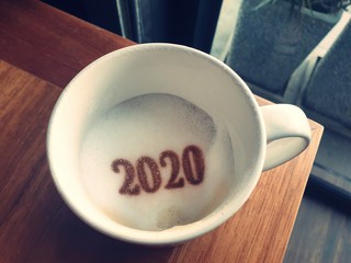 Happy new year 2020, coffee cup with latte art painting, key of success, unlock business in year2020.
