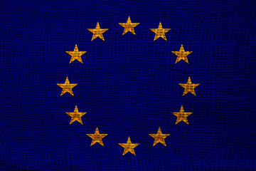 close-up photo of beautiful colored stylized European Union flag, symbol of united Europe on textured fabric, concept of tourism, emigration, economy and politics, close-up