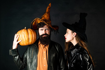 Beauty Halloween girl and Handsome bearded man hold pumpkin on black isolated background.