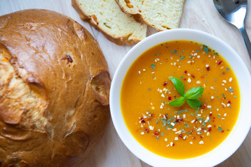 Closeup photo of seasonal autumn pumpkin soup and homemade pumpkin bread