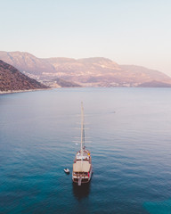 Traditional Turkish Gulets along the mountainous mediterranean coastline at sunset. The luxury...