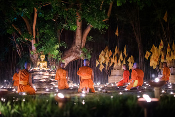 CHIANG MAI, THAILAND - May 18:  Visakha Puja Day Thai monks sitting meditate with many candle at Phan Tao temple  on May 18, 2019 in Chiang Mai, Thailand.