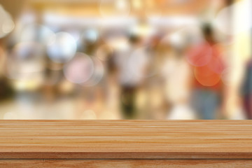 Empty wooden table over abstract bokeh background