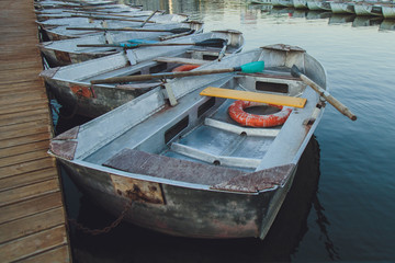 Boat station. Old boats on the water at the pier