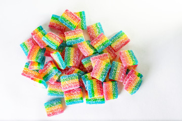 a bunch of rainbow candies on a white background. the view from the top