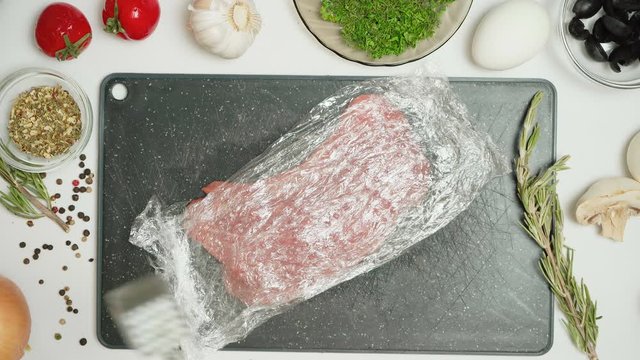 Video of pork and tenderizer in the kitchen