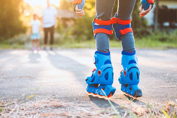 Kid riding on roller skates in the park