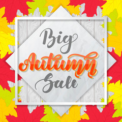 Big autumn sale. Lettering on wooden background with colorful maple leaves. Template for advertising banners, posters, flyers.