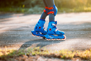 Kid riding on roller skates in the park