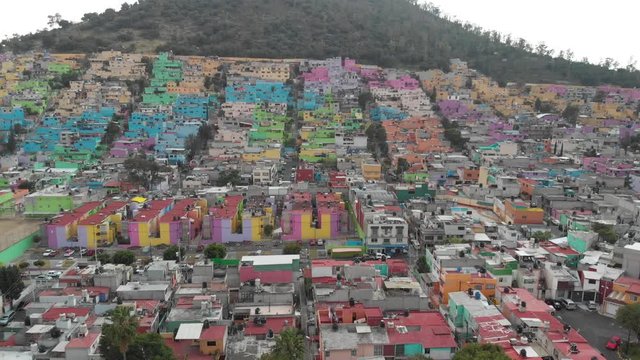 Aerial view of a colorful neighborhood in Ecatepec, Mexico. Drone slowly ascending