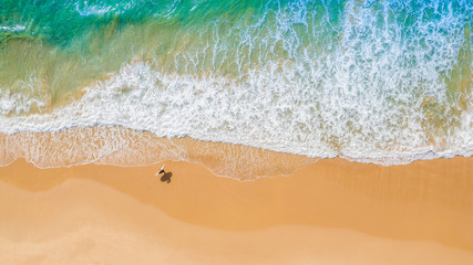 Aerial view of sandy beach and ocean with waves