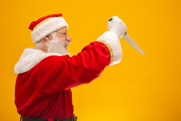 Santa Claus holding a knife. Evil Santa Claus concept. Murder.